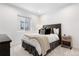 Cozy bedroom featuring a comfortable bed, stylish bedside table, and a large window, creating a serene atmosphere at 9140 Moondance Dr, Littleton, CO 80125
