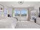 Bright main bedroom featuring large windows, neutral tones, and a decorative chandelier creating a relaxing retreat at 9140 Moondance Dr, Littleton, CO 80125
