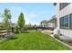 Well-maintained backyard with lawn, patio, privacy fence, deck, and tasteful landscaping at 9140 Moondance Sw Dr, Littleton, CO 80125