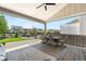 Covered patio with outdoor seating offers views of the beautifully landscaped backyard and surrounding neighborhood at 9140 Moondance Sw Dr, Littleton, CO 80125