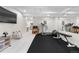 Finished basement with gym, featuring exercise equipment and mirrors, adjacent to rec space at 9140 Moondance Sw Dr, Littleton, CO 80125