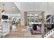 Open floorplan view into dining room and living area with ample natural light and modern decor at 9140 Moondance Sw Dr, Littleton, CO 80125