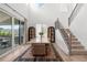 Bright and modern dining room with staircase and sliding door with a view of backyard at 9140 Moondance Sw Dr, Littleton, CO 80125
