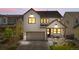 Charming two-story home with landscaped front yard, covered porch, and attached two car garage during sunset at 9140 Moondance Sw Dr, Littleton, CO 80125