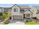 Charming two-story home with landscaped front yard, covered porch, and attached two car garage at 9140 Moondance Sw Dr, Littleton, CO 80125