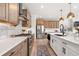 Bright kitchen with stainless appliances, stylish cabinets, marble backsplash and island with barstool seating at 9140 Moondance Sw Dr, Littleton, CO 80125