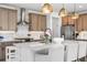 Well-lit kitchen with stainless appliances, stylish cabinets, marble backsplash, and island with seating at 9140 Moondance Sw Dr, Littleton, CO 80125