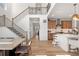 Open view into dining room, staircase, and modern kitchen area with island seating at 9140 Moondance Sw Dr, Littleton, CO 80125