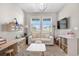 Bright playroom featuring white sofa, large windows, a patterned rug, and plenty of space to play at 9140 Moondance Sw Dr, Littleton, CO 80125