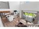 Open-concept living space with a gourmet kitchen, modern fireplace, and seamless indoor-outdoor flow to the patio at 9140 Moondance Sw Dr, Littleton, CO 80125