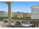 Covered patio with mountain views, outdoor seating and pergola provides relaxation at 9140 Moondance Sw Dr, Littleton, CO 80125