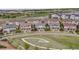 Aerial view of a neighborhood featuring modern homes, green spaces, and pedestrian walkways at 2820 Macon Way, Denver, CO 80238