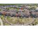 An aerial view shows a well-planned community, highlighted by a central park and tree-lined streets at 2820 Macon Way, Denver, CO 80238