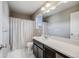 Neutral bathroom featuring a shower and tub combination and a large vanity at 2820 Macon Way, Denver, CO 80238