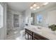Modern bathroom featuring a glass shower, marble accents and a large mirror at 2820 Macon Way, Denver, CO 80238