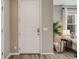 View of a bright entryway with hardwood floors, and a glimpse of the living room at 2820 Macon Way, Denver, CO 80238