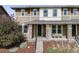 Charming two-story home with a covered front porch, brick pillars, and well-maintained landscaping at 2820 Macon Way, Denver, CO 80238