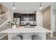 Beautiful kitchen with stainless appliances, dark wood cabinetry, quartz countertops, and pendant lighting at 2820 Macon Way, Denver, CO 80238