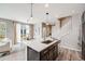 Modern kitchen with stainless steel appliances, quartz countertops, and eat in kitchen island at 2820 Macon Way, Denver, CO 80238