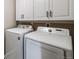 Laundry room features a washer, dryer, and storage cabinets at 2820 Macon Way, Denver, CO 80238