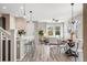 Bright open-concept living room with wood floors, modern lighting, and views from the large windows at 2820 Macon Way, Denver, CO 80238