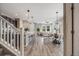Bright open-concept living room with wood floors, modern lighting, and views from the large windows at 2820 Macon Way, Denver, CO 80238