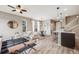 Open-concept living space features hardwood floors, modern furniture, and plenty of natural light at 2820 Macon Way, Denver, CO 80238