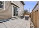 Charming outdoor patio with stone pavers, comfortable seating, and fenced perimeter at 2820 Macon Way, Denver, CO 80238