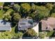 Aerial view of the neighborhood showcases the house, lush landscaping, and solar panels at 6906 S Sycamore St, Littleton, CO 80120