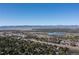 Aerial view showcasing the property's location within a neighborhood and proximity to a nearby lake at 6906 S Sycamore St, Littleton, CO 80120