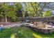 Landscaped backyard features a serene stone water feature and bench seating, perfect for enjoying the outdoors at 6906 S Sycamore St, Littleton, CO 80120