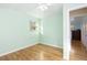 Light-filled bedroom features hardwood floors, neutral walls, and a window offering natural light at 6906 S Sycamore St, Littleton, CO 80120