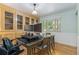 Comfortable dining area showcasing built-in display cabinets, hardwood floors, and a large table used as an office space at 6906 S Sycamore St, Littleton, CO 80120