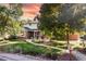 Charming two-story home with brick accents, a manicured lawn, and mature shade trees at 6906 S Sycamore St, Littleton, CO 80120
