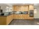 Updated kitchen with light wood cabinets, a modern backsplash, and a view of the front yard at 6906 S Sycamore St, Littleton, CO 80120