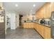 Spacious kitchen featuring stainless steel appliances, light wood cabinetry, and an open layout at 6906 S Sycamore St, Littleton, CO 80120