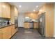Clean kitchen with light wood cabinets, stainless steel appliances, and modern backsplash at 6906 S Sycamore St, Littleton, CO 80120