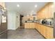 Contemporary kitchen featuring wood cabinets, stainless steel appliances, and an open layout to the living room at 6906 S Sycamore St, Littleton, CO 80120