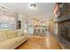 Open-concept living room with hardwood floors, fireplace, and easy access to the kitchen at 6906 S Sycamore St, Littleton, CO 80120