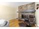Living room with stone fireplace, hardwood floors, and comfortable seating at 6906 S Sycamore St, Littleton, CO 80120