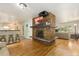 Open living space with fireplace, hardwood floors, and bar seating to the kitchen at 6906 S Sycamore St, Littleton, CO 80120