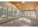 Bright sunroom with wood ceiling, windows galore, and carpeted floors at 6906 S Sycamore St, Littleton, CO 80120