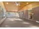 Spacious sunroom with wood ceiling, carpeted floors, brick accent wall, and lots of windows at 6906 S Sycamore St, Littleton, CO 80120