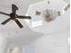 High ceiling with a ceiling fan and chandelier, complemented by plenty of natural light at 7882 Vallagio Ln, Englewood, CO 80112