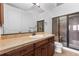 Well-lit bathroom featuring a granite countertop, and glass-enclosed shower at 7882 Vallagio Ln, Englewood, CO 80112