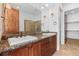 Bathroom with granite countertops, double sinks, and a walk-in shower at 7882 Vallagio Ln, Englewood, CO 80112