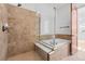 Walk-in shower with a bathtub with tile and a glass enclosure at 7882 Vallagio Ln, Englewood, CO 80112
