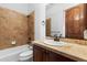 Bathroom with tiled shower, vanity, and toilet at 7882 Vallagio Ln, Englewood, CO 80112
