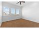 Bright bedroom with large windows, plush carpeting, and a ceiling fan at 7882 Vallagio Ln, Englewood, CO 80112