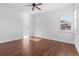 Bedroom with hardwood floors, a ceiling fan, and a bright window at 7882 Vallagio Ln, Englewood, CO 80112